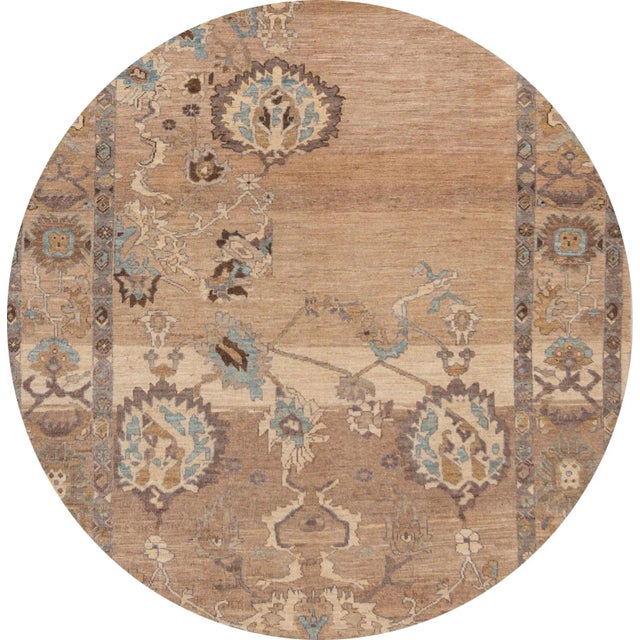 A hand-knotted Sultanabad rug with a floral design and border on a brown field. Accents of beige, blue and dark brown...