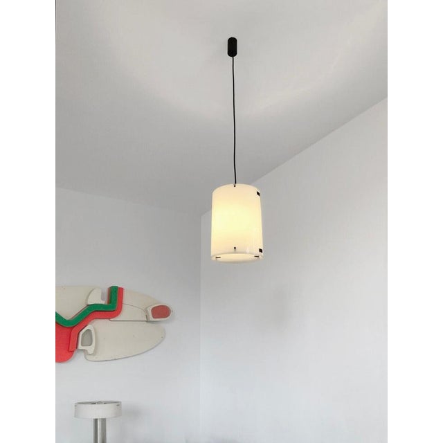 An authentic cylindrical pendant light, radical, modernist, fifties, minimalist, diffusing white perspex cylinder...