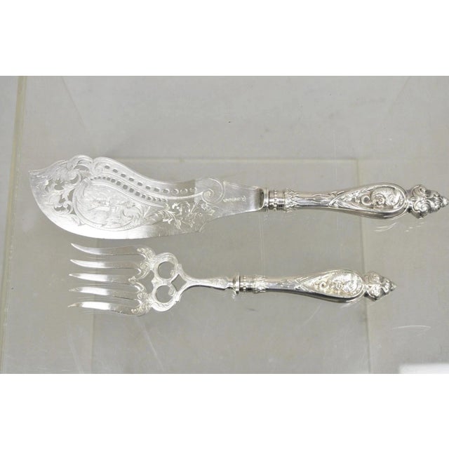 Antique English Victorian Silver Plated Figural Fish Service Fork Knife Set. Item features cherub and dolphin design to...