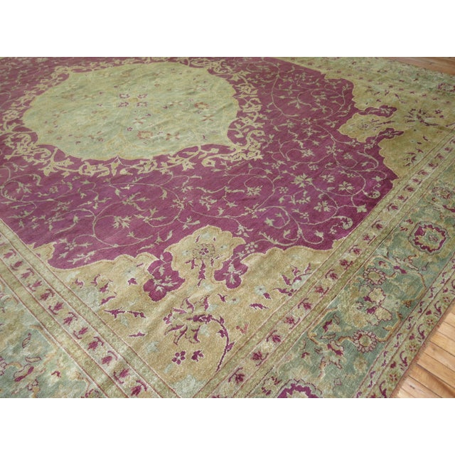 An early 20th century Turkish Ghiordes rug. Plum field, mint green medallion and border with gold accents. Measures:...
