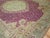 An early 20th century Turkish Ghiordes rug. Plum field, mint green medallion and border with gold accents. Measures:...