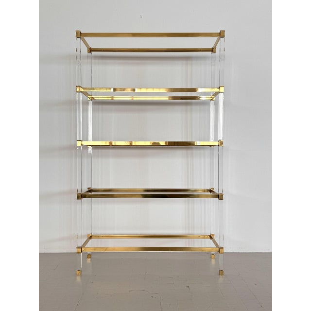 Large, elegant freestanding shelf with five shelves. The shelf frame is made of transparent polycarbonate, the shelves are...