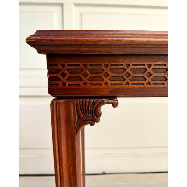 This elegant mid-century console table is crafted in the Chinese Chippendale style and features a beautifully proportioned...