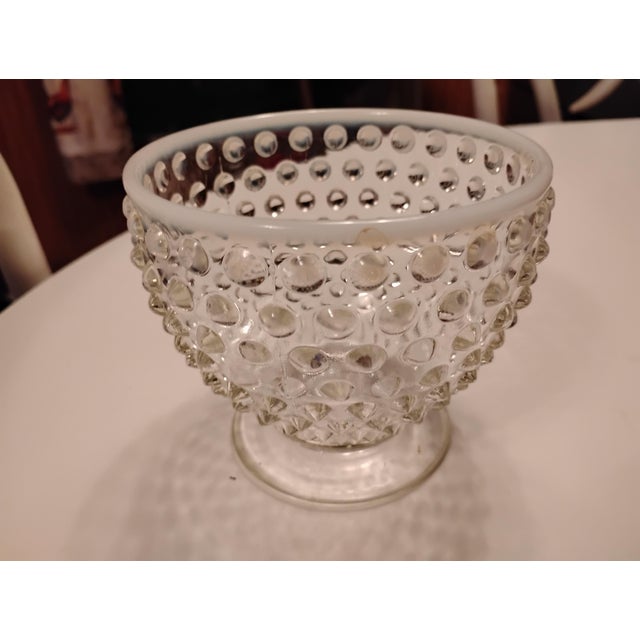 The Fenton Moonstone Hobnail Glass Bowl is a vintage piece of art glass from the Americas, specifically the United States....