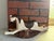 Charming vintage wooden rocking horse featuring a hand-painted finish in warm brown and cream tones. The piece reflects a...
