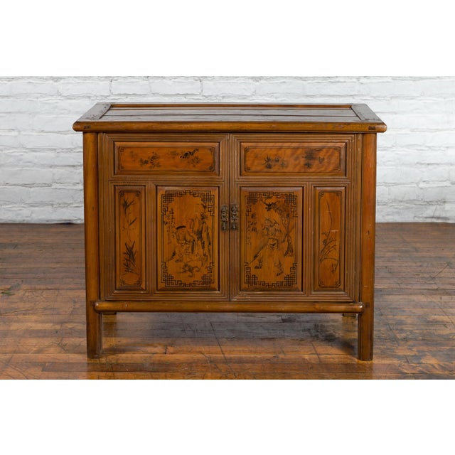 A Chinese antique cabinet from the early 20th century, with Chinoiserie décor and hidden double drawers. Created in China...