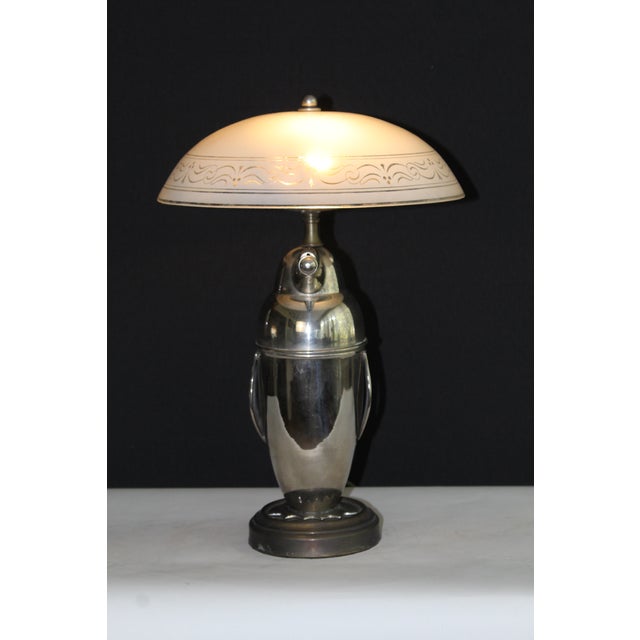 Unusual Bauhaus sculptural penguin. Silver overlay on copper. Mounted on an antique bronze finish base. Embossed glass...