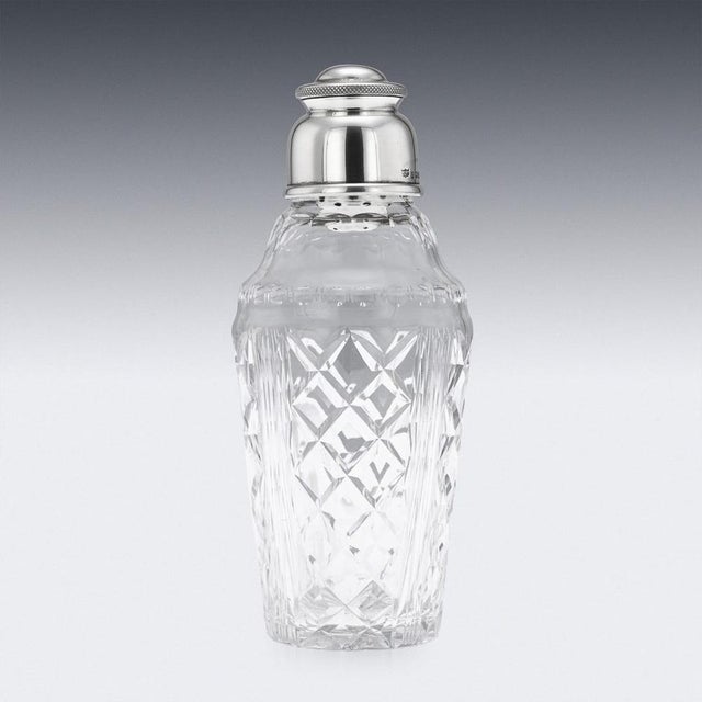 A wonderful 20th century english solid silver and cut glass cocktail shaker, of tapering form, made from glass with a...