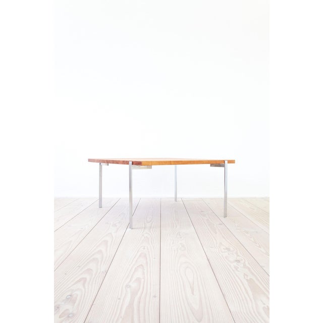 The Poul Kjærholm style salon table comes from Denmark and consists of a solid pear wood leaf on four steel legs. It has...