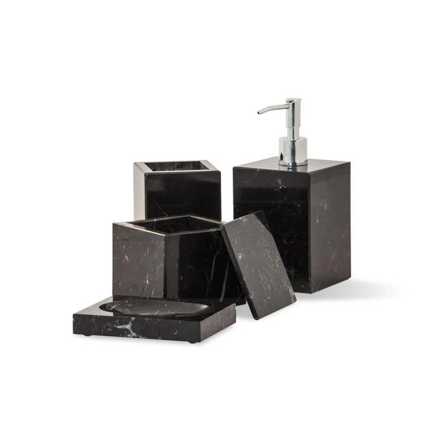 A squared set for the bathroom in black Marquina marble which includes: one soap dispenser (9 x 9 x 19 cm), one soap dish...