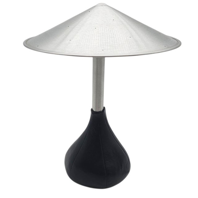 With the grace of a city night and the discipline of design, this rare Piccola lamp nestles its teardrop leather base like...