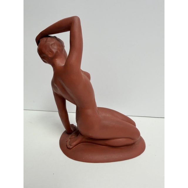 Offered here is a vintage modern ceramic sculpture depicting a reclining nude female figure in a graceful seated pose....