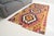 This is a vintage Turkish Oushak rug from the Mid 20th Century. The piece was hand-knotted.