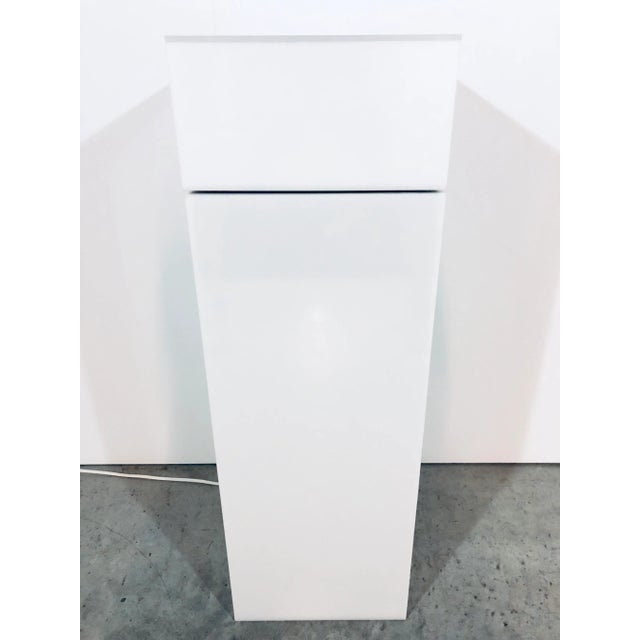 Rotating turntable top white lucite pedestal table by Haziza. The top rotates via internal motor when switched on.