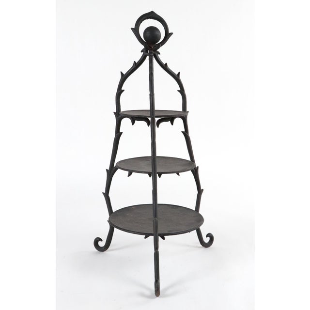 Art Nouveau cast iron three tier display piece with a natural undulating design and slight Gothic influence in the tracery...