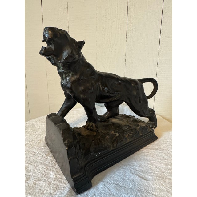 Art Deco roaring tiger bookend by Ronson, circa 1925 This impressive cast metal bronzed sculpture by Ronson, titled “Roar...