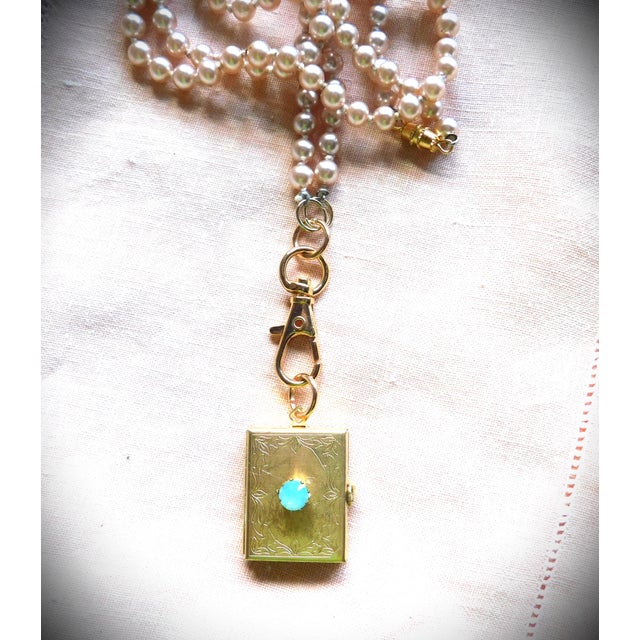 Luxurious Vintage etched four photo gold locket with a high-pronged faceted pacific opal stone. This beautiful brass...
