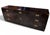 Handsome mid-century modern campaign style credenza or media cabinet featuring a dramatic ebonized case with contrasting...