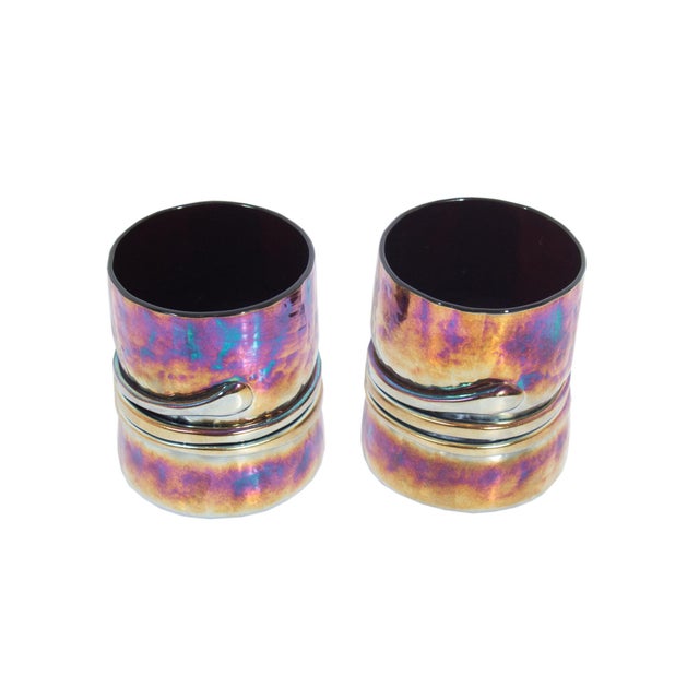 A pair of art glass tumblers by the American glass artist Esteban Prieto. These glasses are made from an iridescent glass...
