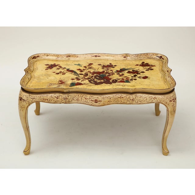 Decorated with floral blossoms and birds in crimson, blue, and gilt on an ivory ground; the shaped removable tray top on a...