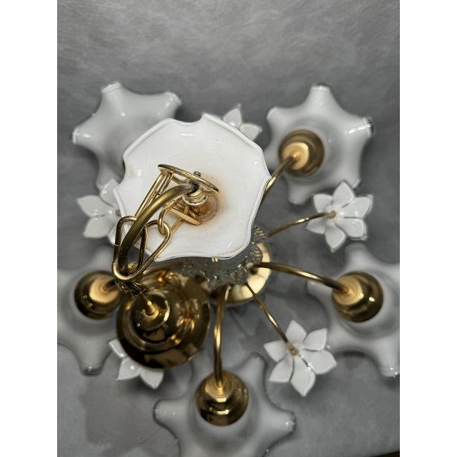 Elegant five-arm chandelier featuring with decorative floral milk glass shades. There is one very small chip on one of the...