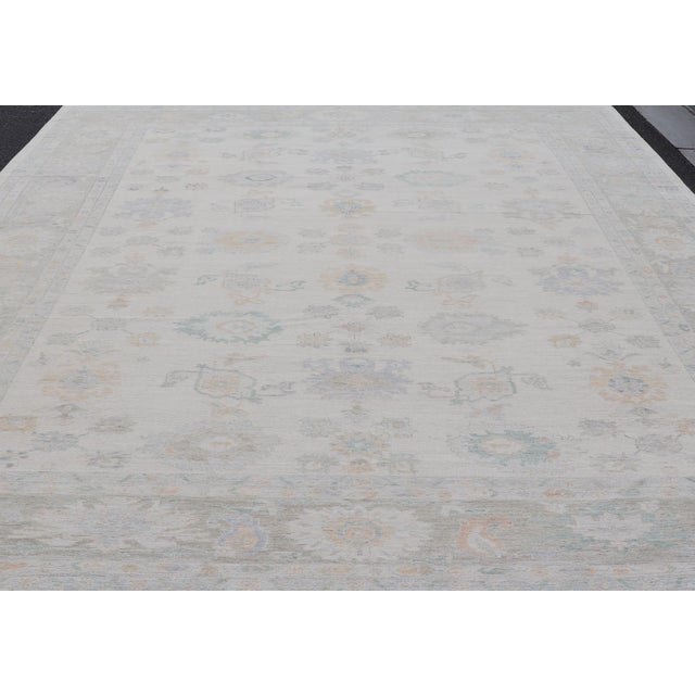 Tribal Oushak Rug With Ivory Soft Pastel Accents in Sage, Peach, and Blue 12'3 X 17'10 For Sale - Image 3 of 11