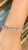 This is part of Chairish’s Fine Jewelry assortment. This Sparkling Blue Topaz Tennis Bracelet in 18K gold showcases 25...