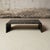 A 1970s French coffee table featuring a substantial rectangular top in dark marble with natural veining. The piece is...