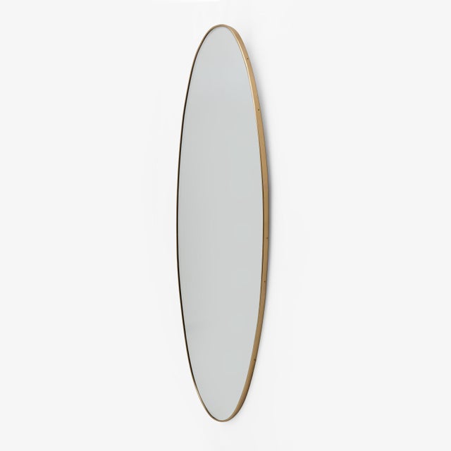 Italian oval mirror with a brass frame, attributed to Gio Ponti. Its classic shape embodies Italian modernist design. The...