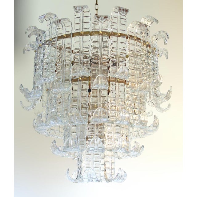 Italian chandelier shown with four tiers of clear hand blown Murano Felci fern glasses mounted on bronzed finish metal...