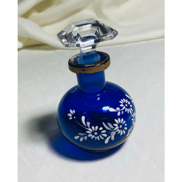 Cobalt blue round crystal perfume bottle white enamel painted flowers with gold rim & faceted crystal stopper
