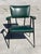 Colette Gueden armchair in green faux leather with black stitching. Tubular steel frame, re-lacquered black, and...