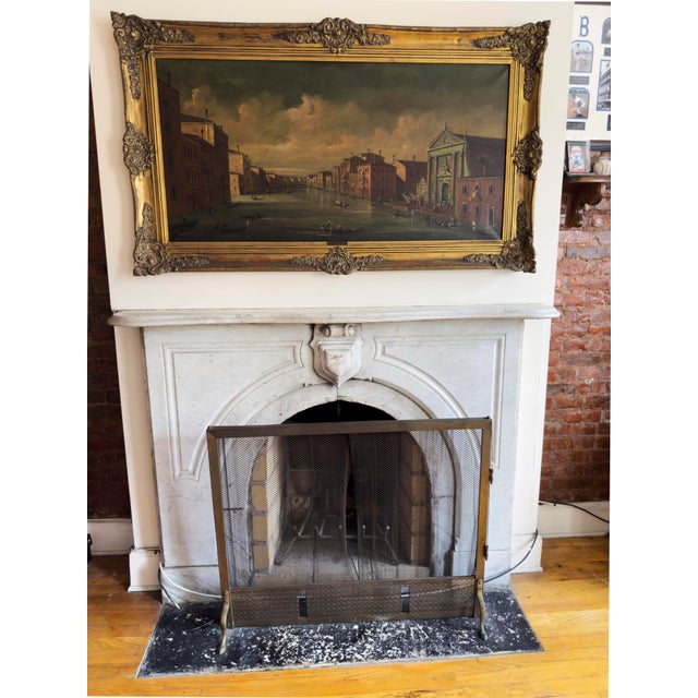 Vintage mid-century brass fireplace screen with mesh curtain, combining French Provincial and Hollywood Regency design...