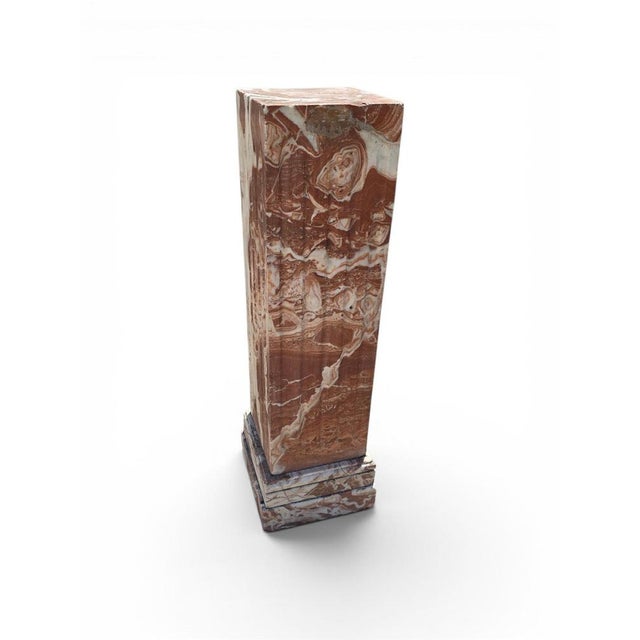 Elegant pedestal carved from richly veined reddish marble, dating from the first half of the 20th century. Distinguished...