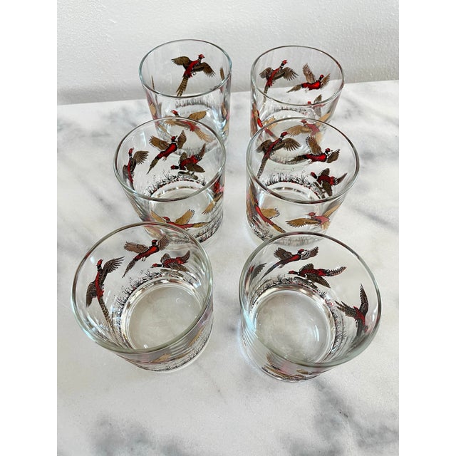 A set of vintage Hazel Atlas glass tumblers featuring a hunting scene with red and gold pheasants. This type of glass was...