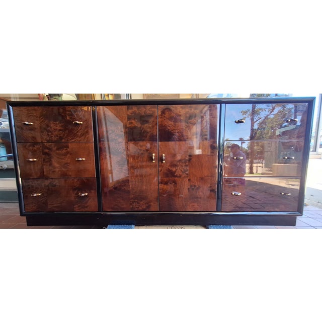 1980's signed burlwood Henredon scene three credenza is in near fine condition. It measures 30" h x 68" a x 18" d. Be sure...