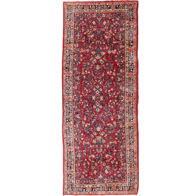 Antique Sarouk Long Gallery Runner With All-Over Flower Design in Red Background For Sale