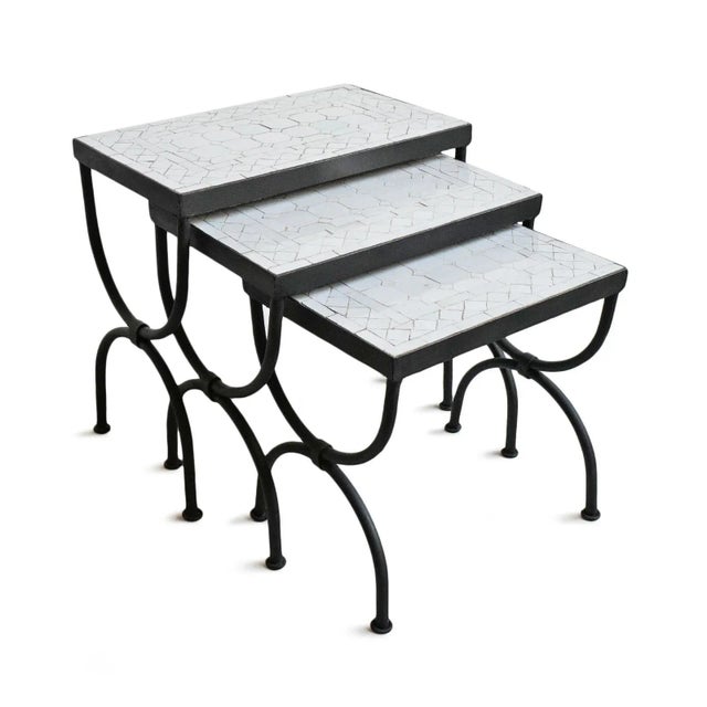 Outdoor white mosaic nesting tables with black iron base. Set of three. Small imperfections are to be expected due to...