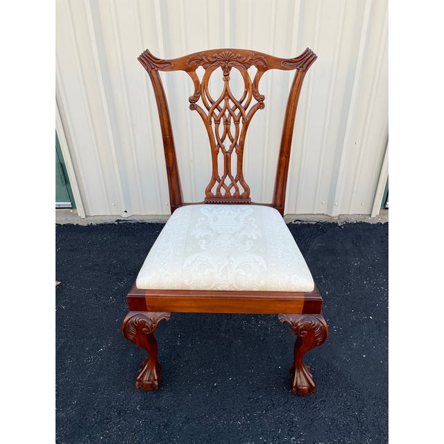 A set of ten Chippendale style mahogany dining room chairs with ball and claw feet. High quality design styled after...