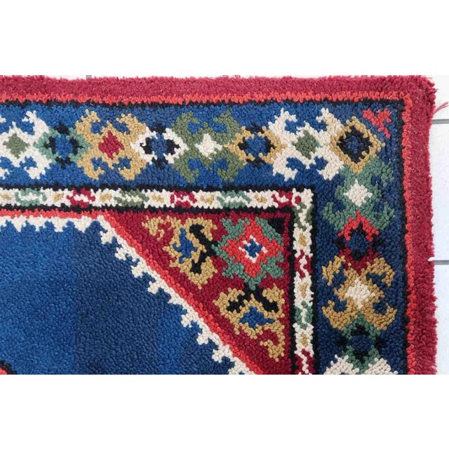 Vintage French Savonnerie rug in blue and red colors. The rug has been made in wool in the end of 20th century. It is in...