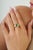 This dome ring showcases a 1.19 carat pear-shaped emerald set in 14k yellow gold. The emerald measuring approximately 7 x...