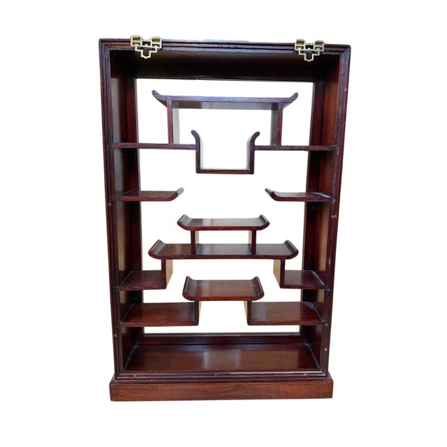 Add timeless elegance to your home with this vintage Chinese carved rosewood wall-mounted curio display cabinet. Crafted...
