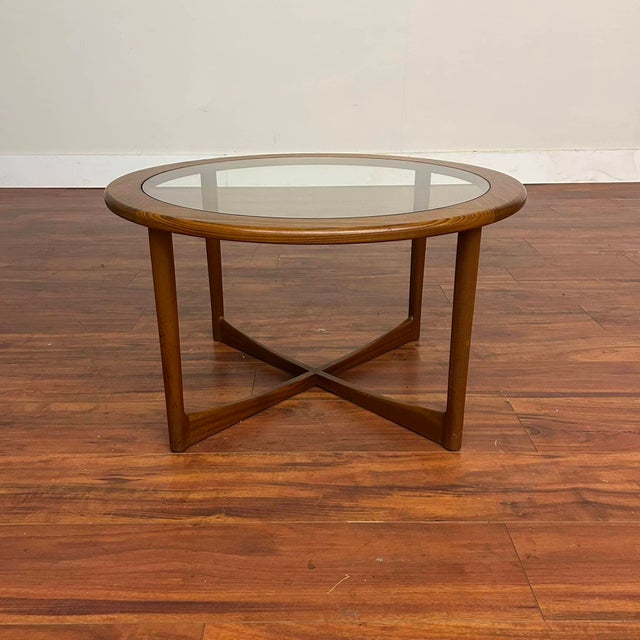 Beautiful round teak coffee table with glass top insert, made in Scotland by A.H. McIntosh in 1971. It's a very cool,...