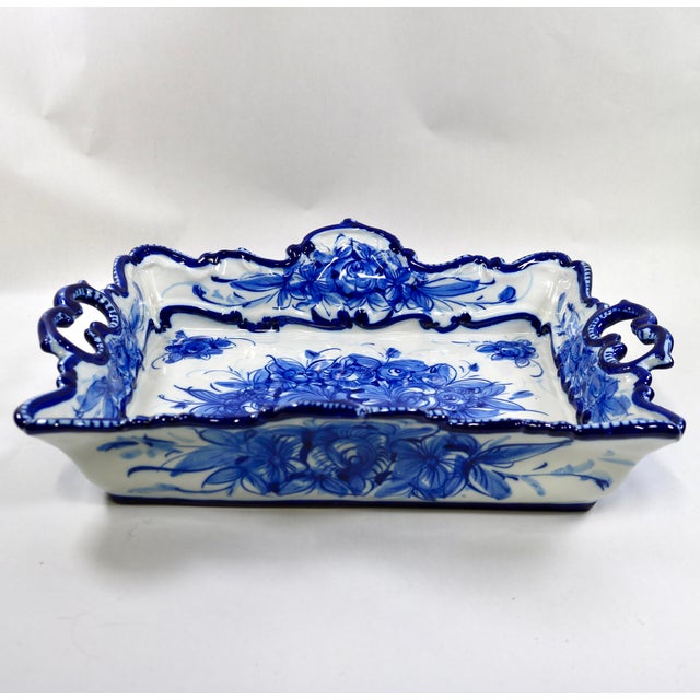 The Mid-century Vestal Alcobaca Portugal Blue and White Floral Handled Serving Tray is a stylish and elegant piece of...