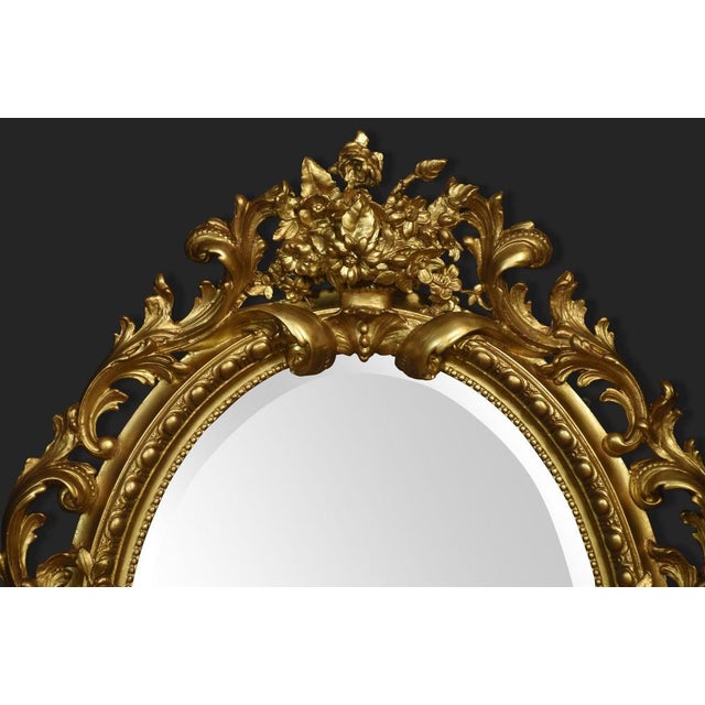 Very large early 19th-century wall mirror, the well-carved frame decorated with foliated and scrolling detail surrounding...