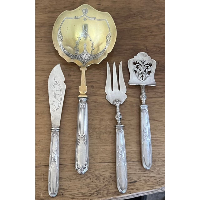 Set of four serving utensils made in France around 1900. French hallmarked with the Minerva for sterling silver, the spoon...