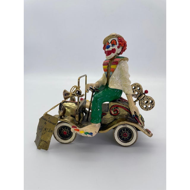 A charming vintage figural sculpture by celebrated California artist Ronald A. Lee, depicting a cheerful clown seated atop...
