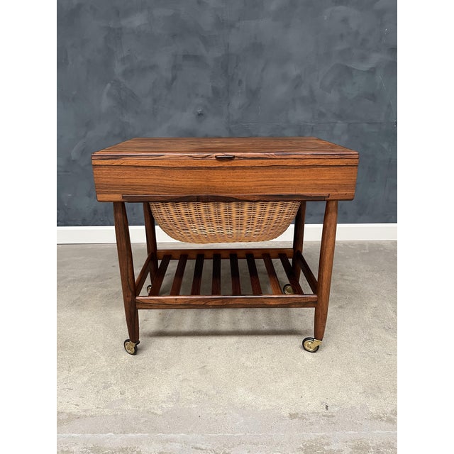 Elegant and beautifully crafted sewing table designed by Ejvind A. Johansson in the 1960s. Made in richly grained...