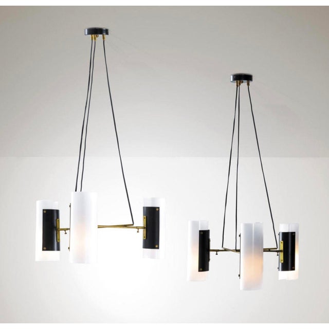 Pair of vintage light pendants by Stilux, Italy, c. 1960's. They each consist of a brass and lacquered metal frames and...