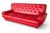 A striking vintage three-seater sofa upholstered in vibrant red leather, featuring classic deep button tufting across the...